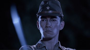 Movie still from “Merry Christmas Mr. Lawrence” (1983), directed by Nagisa Ôshima – A man wearing a hat with a star on it's brim; Close Up shot, Low angle