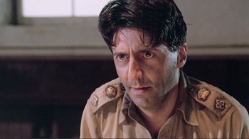 Movie still from “Merry Christmas Mr. Lawrence” (1983), directed by Nagisa Ôshima – A person wearing a military uniform; Close Up shot, Low angle