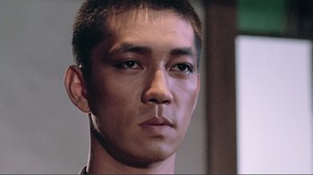 Movie still from “Merry Christmas Mr. Lawrence” (1983), directed by Nagisa Ôshima – A man's face in a room; Close Up shot, Low angle