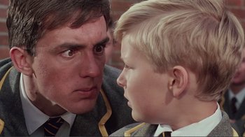 Movie still from “Merry Christmas Mr. Lawrence” (1983), directed by Nagisa Ôshima – A man and a boy are looking at each other; Close Up shot, Over the shoulder angle