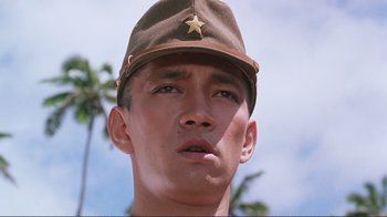 Movie still from “Merry Christmas Mr. Lawrence” (1983), directed by Nagisa Ôshima – A person wearing a hat; Close Up shot, Low angle