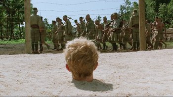 Movie still from “Merry Christmas Mr. Lawrence” (1983), directed by Nagisa Ôshima – A young boy is looking up at a group of soldiers; Wide shot, High angle