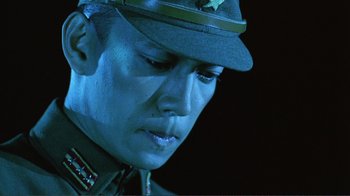Movie still from “Merry Christmas Mr. Lawrence” (1983), directed by Nagisa Ôshima – A person wearing a uniform; Close Up shot, Low angle