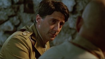 Movie still from “Merry Christmas Mr. Lawrence” (1983), directed by Nagisa Ôshima – A person wearing a military uniform; Close Up shot, Over the shoulder angle
