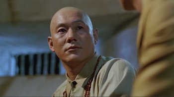 Movie still from “Merry Christmas Mr. Lawrence” (1983), directed by Nagisa Ôshima – A man with a bald head is looking into the distance; Close Up shot, Low angle