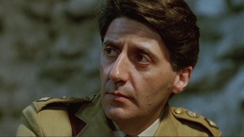 Movie still from “Merry Christmas Mr. Lawrence” (1983), directed by Nagisa Ôshima – A person wearing a military uniform; Close Up shot, Low angle