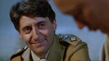 Movie still from “Merry Christmas Mr. Lawrence” (1983), directed by Nagisa Ôshima – A person wearing a military uniform; Close Up shot, Over the shoulder angle