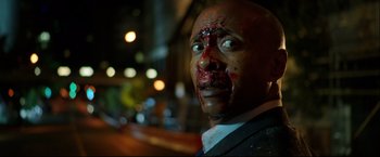 Movie still from “Metallica Through the Never” (2013), directed by Nimród Antal – A person with blood all over his face; Close Up shot, High angle