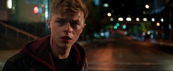 Movie still from “Metallica Through the Never” (2013), directed by Nimród Antal – A young man with blood all over his face; Close Up shot, Over the shoulder angle