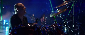 A man playing drums in front of a crowd