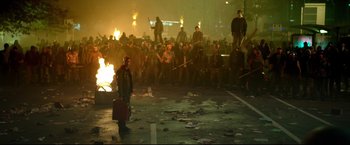 Movie still from “Metallica Through the Never” (2013), directed by Nimród Antal – A group of people standing in front of a fire pit; Wide shot, High angle