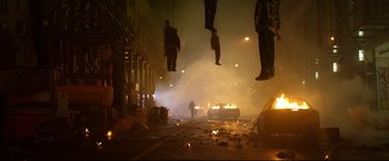 Movie still from “Metallica Through the Never” (2013), directed by Nimród Antal – A group of people hanging from a rope next to a fire; Wide shot, Low angle