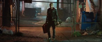 Movie still from “Metallica Through the Never” (2013), directed by Nimród Antal – A young man holding a bag and a guitar case; Wide shot, Low angle