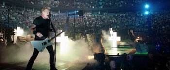 Movie still from “Metallica Through the Never” (2013), directed by Nimród Antal – A large crowd of people in a stadium; Wide shot, Low angle
