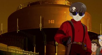 Movie still from “Metropolis” (2001), directed by Rintarô – An animated picture of a man in a red shirt; Medium shot, Low angle