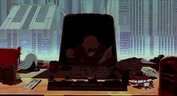 Movie still from “Metropolis” (2001), directed by Rintarô – A computer screen with a cartoon of a man sitting at a desk; Wide shot, Low angle