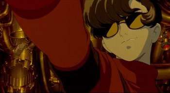 Movie still from “Metropolis” (2001), directed by Rintarô – A person wearing sunglasses and a red jacket; Close Up shot, Low angle