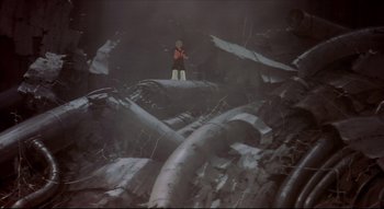 Movie still from “Metropolis” (2001), directed by Rintarô – A man standing on top of a log in a dark forest; Extreme Wide shot, Low angle