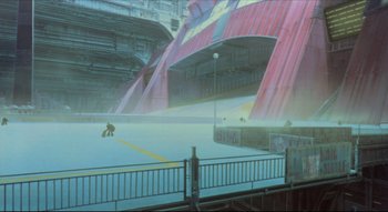Movie still from “Metropolis” (2001), directed by Rintarô – An empty parking lot in a futuristic city; Extreme Wide shot, High angle
