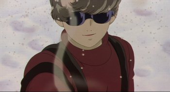 Movie still from “Metropolis” (2001), directed by Rintarô – A man wearing sunglasses and a red shirt; Close Up shot, Low angle