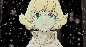 Movie still from “Metropolis” (2001), directed by Rintarô – A cartoon of a woman with blonde hair and green eyes; Close Up shot, Low angle