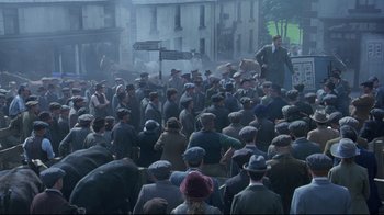 Movie still from “Michael Collins” (1996), directed by Neil Jordan – A group of men in a crowd of people; Extreme Wide shot, High angle
