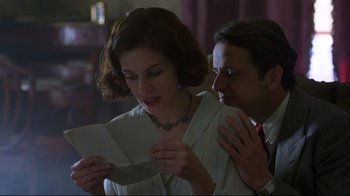 Movie still from “Michael Collins” (1996), directed by Neil Jordan – A man and a woman looking at a piece of paper; Close Up shot, Low angle