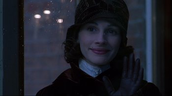 Movie still from “Michael Collins” (1996), directed by Neil Jordan – A young woman wearing a hat is smiling; Close Up shot, Over the shoulder angle