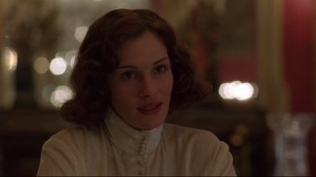 Movie still from “Michael Collins” (1996), directed by Neil Jordan – A woman in a white shirt is looking at the camera; Close Up shot, Over the shoulder angle