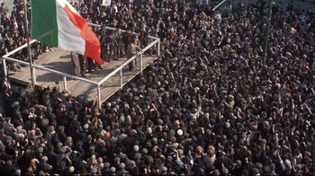 Movie still from “Michael Collins” (1996), directed by Neil Jordan – A large crowd of people gathered in the street; Extreme Wide shot, High angle