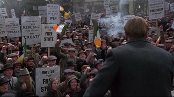 Movie still from “Michael Collins” (1996), directed by Neil Jordan – A large crowd of people protesting in a city; Wide shot, High angle
