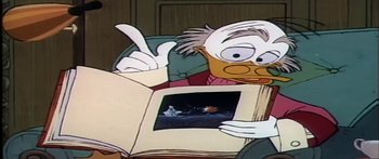 Movie still from “Mickey and the Beanstalk” (1947), directed by Hamilton Luske – An old man is reading a picture book; Medium shot, High angle