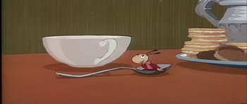 Movie still from “Mickey and the Beanstalk” (1947), directed by Hamilton Luske – A cartoon of a person sitting on a spoon next to a coffee cup; Extreme Close Up shot, High angle
