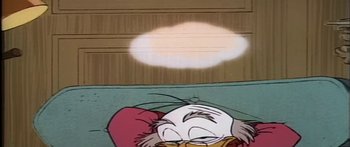 Movie still from “Mickey and the Beanstalk” (1947), directed by Hamilton Luske – A cartoon duck sleeping on a bed; Extreme Close Up shot, High angle