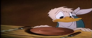Movie still from “Mickey and the Beanstalk” (1947), directed by Hamilton Luske – A plate with a duck on it's side; Close Up shot, High angle