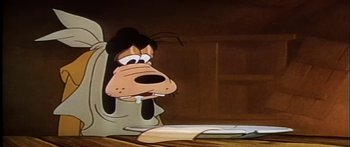 Movie still from “Mickey and the Beanstalk” (1947), directed by Hamilton Luske – A goofy dog is sitting in front of a desk; Close Up shot, Low angle