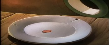 Movie still from “Mickey and the Beanstalk” (1947), directed by Hamilton Luske – A white plate with a slice of pepperoni on it; Extreme Close Up shot, High angle