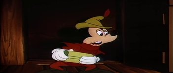 Movie still from “Mickey and the Beanstalk” (1947), directed by Hamilton Luske – A mickey mouse character holding a box in his hands; Medium shot, Low angle