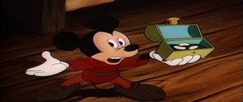 Movie still from “Mickey and the Beanstalk” (1947), directed by Hamilton Luske – A mickey mouse holding a box in his hand; Medium shot, Low angle