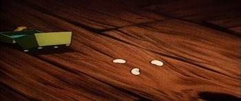 Movie still from “Mickey and the Beanstalk” (1947), directed by Hamilton Luske – A wooden floor with a green object on it; Extreme Close Up shot, High angle