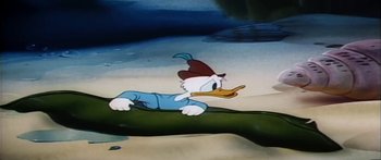 Movie still from “Mickey and the Beanstalk” (1947), directed by Hamilton Luske – A picture of a cartoon duck on a tree branch; Medium shot, High angle