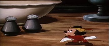 Movie still from “Mickey and the Beanstalk” (1947), directed by Hamilton Luske – A goofy looking mickey mouse sitting on the floor; Medium shot, Low angle
