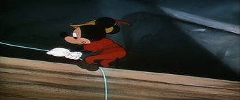 Movie still from “Mickey and the Beanstalk” (1947), directed by Hamilton Luske – A mickey mouse character is shown in a video game; Wide shot, Overhead angle