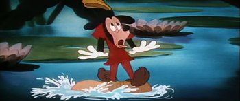 Movie still from “Mickey and the Beanstalk” (1947), directed by Hamilton Luske – A goofy cartoon character is standing in the water; Medium shot, Low angle