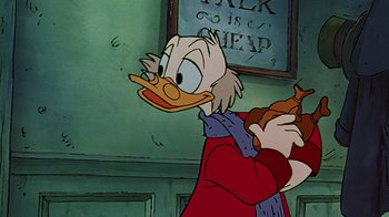 Movie still from “Mickey's Christmas Carol” (1983), directed by Burny Mattinson – A cartoon character holding a cat; Close Up shot, Over the shoulder angle