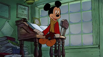 Movie still from “Mickey's Christmas Carol” (1983), directed by Burny Mattinson – Mickey mouse sitting at a desk in a room; Medium shot, Low angle