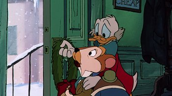 Movie still from “Mickey's Christmas Carol” (1983), directed by Burny Mattinson – A cartoon of scrooge mcduck holding a knife; Medium shot, Over the shoulder angle