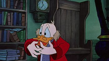 Movie still from “Mickey's Christmas Carol” (1983), directed by Burny Mattinson – A cartoon of scrooge mcduck eating a sandwich; Close Up shot, Over the shoulder angle