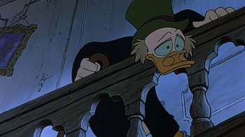 Movie still from “Mickey's Christmas Carol” (1983), directed by Burny Mattinson – A cartoon of scrooge mcduck holding a gun; Medium shot, Low angle