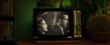 Movie still from “Micmacs” (2009), directed by Jean-Pierre Jeunet – An old tv with a picture of a man and a woman in a car; Extreme Close Up shot, High angle